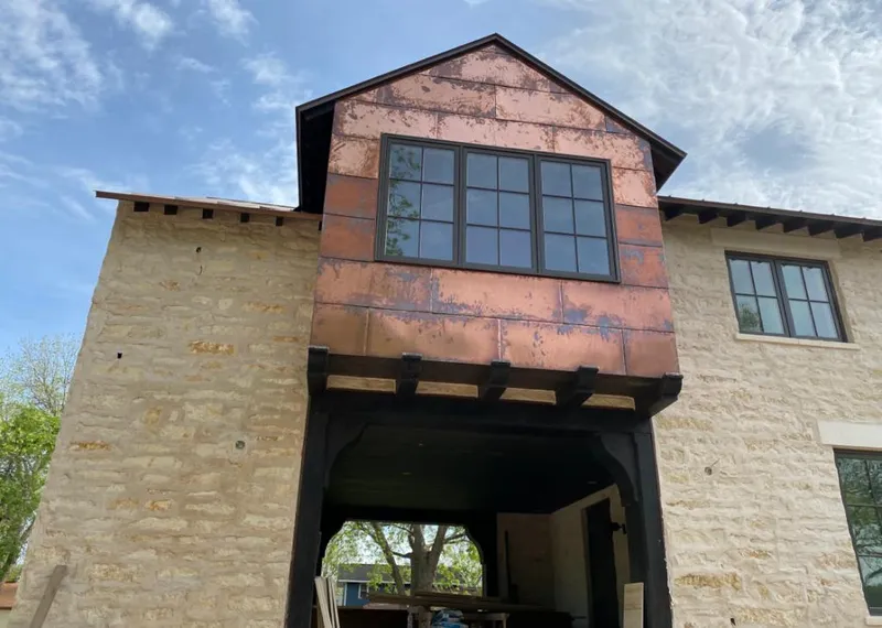 Copper metal panel facade on a stone building for Roof Repair in Lake Murray of Richland